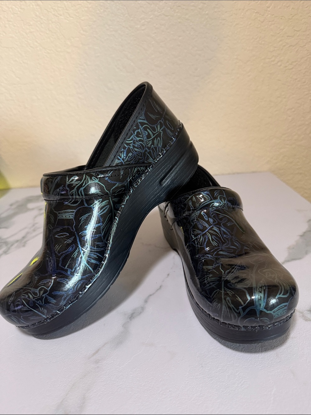 Dansko Black Iridescent Floral Clogs